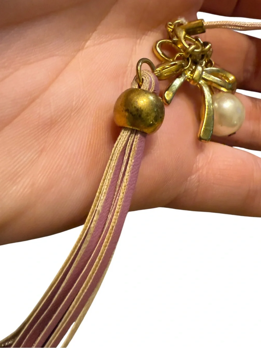 BENEIGE handmade bow and pearl bag charm featuring a gold-toned bow accent